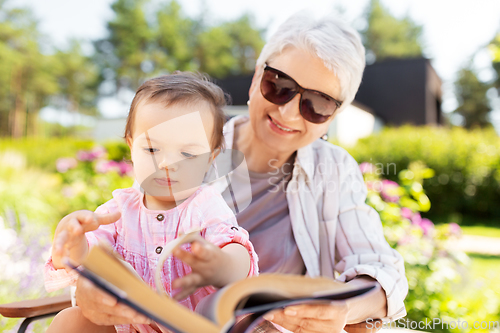 Image of grandmother and baby granddaughter reading book