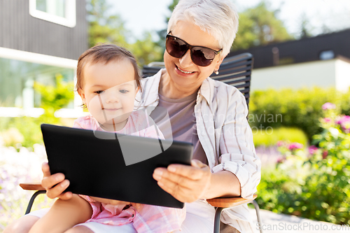 Image of grandmother and baby granddaughter with tablet pc