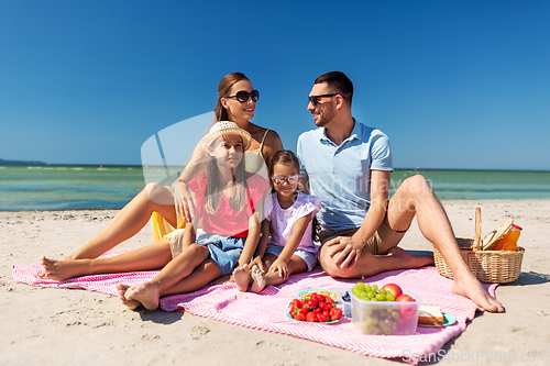 Image of happy family having picnic on summer beach