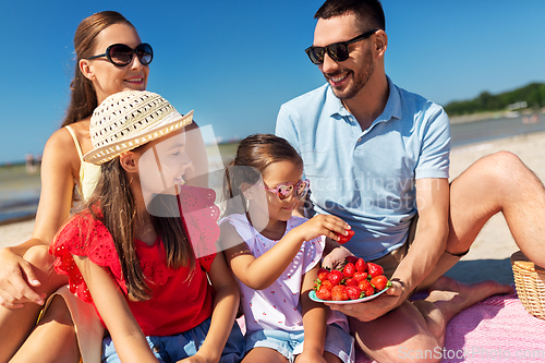 Image of happy family having picnic on summer beach