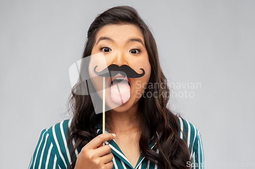 Image of asian woman with vintage moustaches party prop