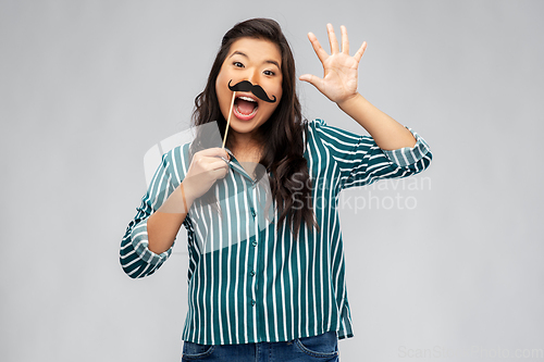 Image of asian woman with vintage moustaches party prop