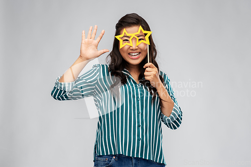 Image of happy asian woman with star-shaped party glasses