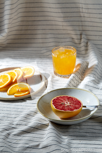 Image of grapefruit, sliced orange and glass of juice