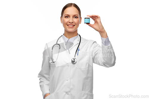 Image of smiling female doctor holding jar of medicine