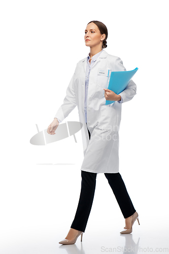 Image of female doctor or scientist walking with folder