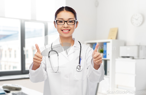 Image of asian female doctor showing thumbs up at hospital