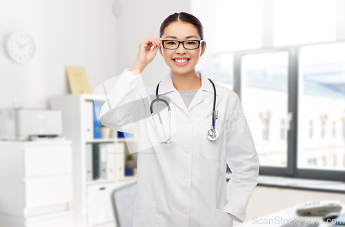 Image of happy asian female doctor in glasses at hospital