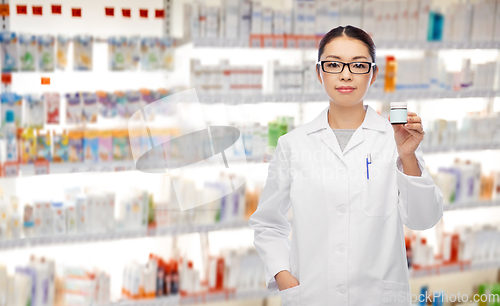 Image of asian female pharmacist with medicine at pharmacy