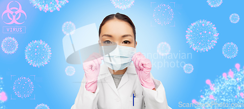 Image of asian female doctor in medical mask and gloves