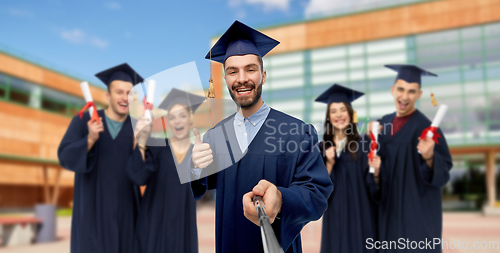 Image of male graduate student taking selfie with monopod