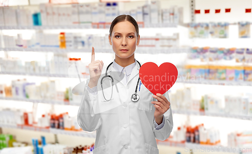 Image of female doctor with heart pointing finger up