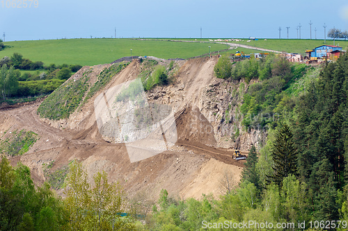 Image of opencast mining quarry with machinery
