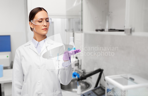 Image of female scientist with chemical at laboratory