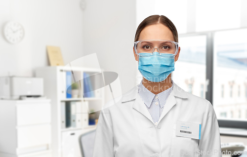 Image of female scientist in medical mask and goggles