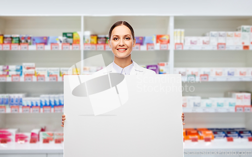 Image of happy smiling female pharmacist with white board