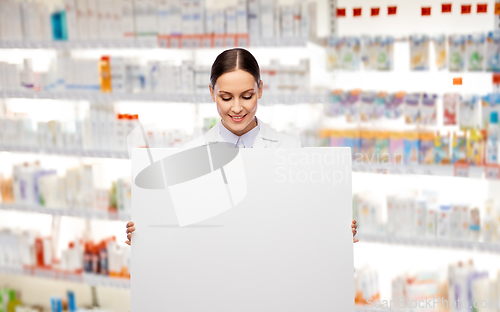 Image of happy smiling female pharmacist with white board