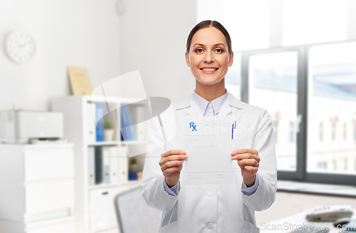 Image of smiling female doctor with prescription blank