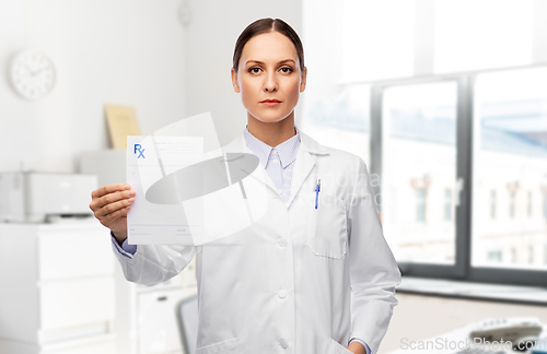 Image of female doctor with prescription blank