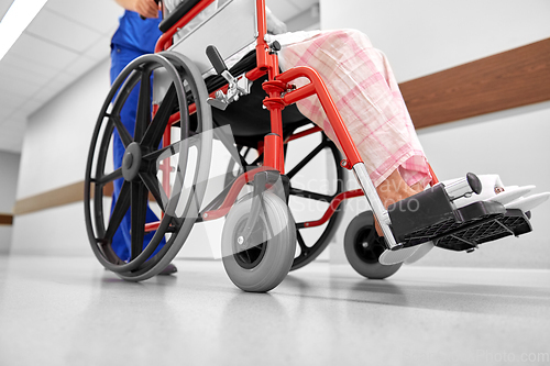 Image of nurse with senior patient in wheelchair at clinic