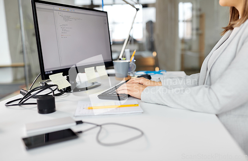 Image of businesswoman with computer working at office