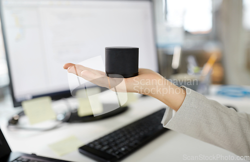 Image of businesswoman using smart speaker at office