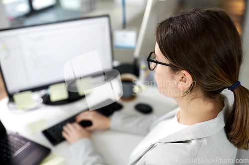 Image of businesswoman with computer working at office