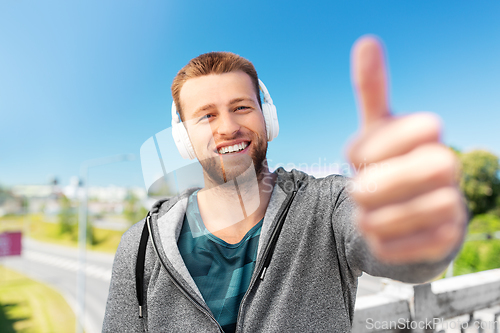 Image of happy smiling man in headphones listening to music