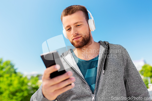 Image of young man with headphones and smartphone