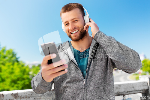 Image of young man with headphones and smartphone