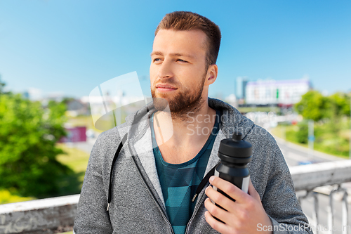 Image of young man with sports bottle