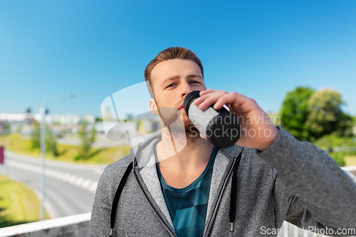 Image of young man with sports bottle