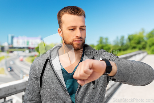 Image of man with smart watch outdoors