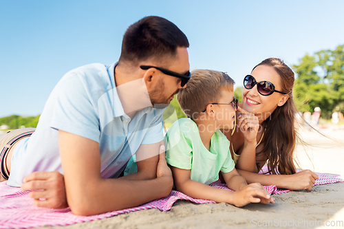 Image of family lying on summer beach