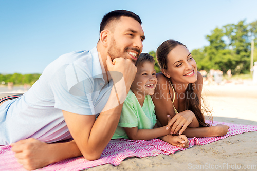 Image of family lying on summer beach