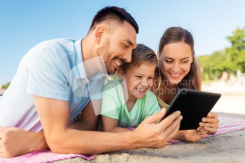 Image of happy family with tablet computer on summer beach