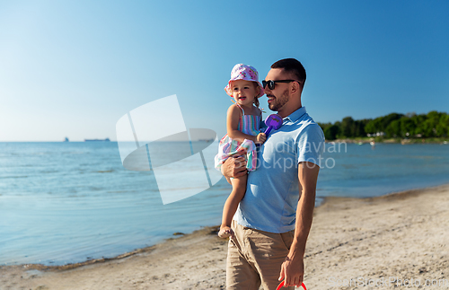 Image of happy father with little daughter on beach