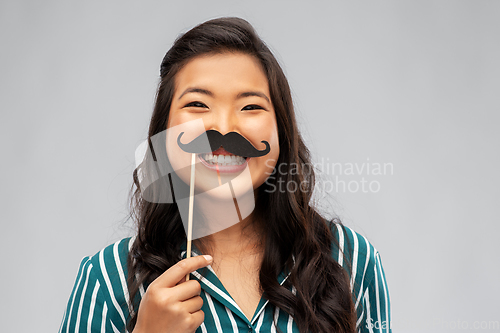 Image of asian woman with vintage moustaches party prop