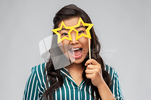 Image of happy asian woman with star-shaped party glasses