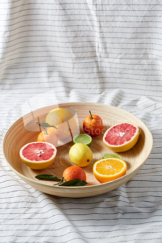 Image of close up of citrus fruits on wooden plate