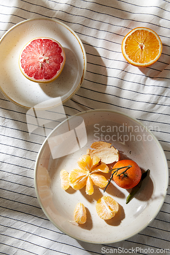 Image of still life with mandarins and grapefruit on plate