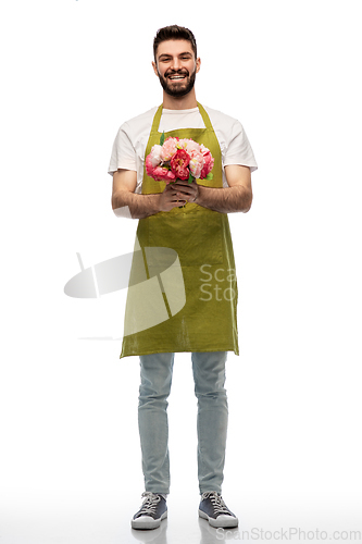 Image of smiling male gardener with bunch of peony flowers