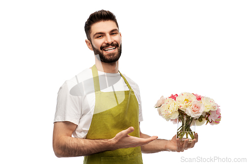 Image of smiling male gardener with bunch of peony flowers