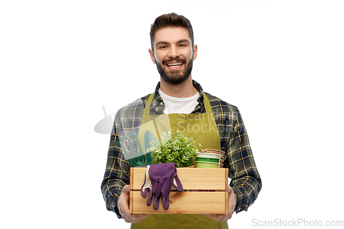 Image of happy gardener or farmer with box of garden tools