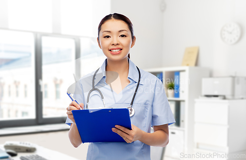 Image of asian female doctor with clipboard at hospital