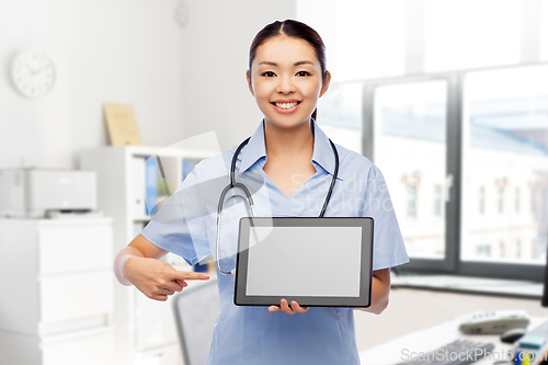 Image of asian female nurse with tablet pc at hospital