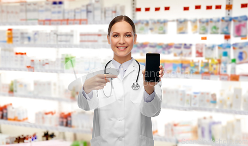 Image of happy female doctor or nurse with smartphone