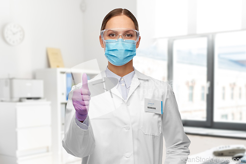 Image of female scientist in medical mask and goggles