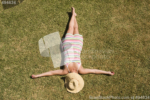 Image of woman laying in the grass