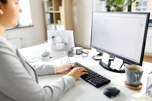 Image of businesswoman with computer working at office